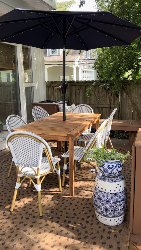 outdoor patio table and bistro chairs with umbrella